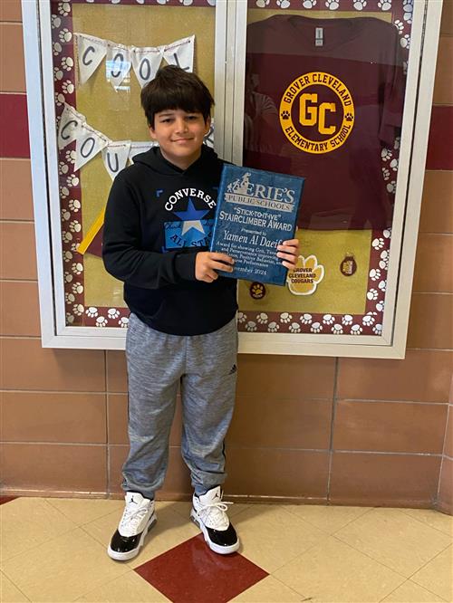 Yamen Al Daeif, Grover Cleveland's Stairclimber for November, poses with his plaque.